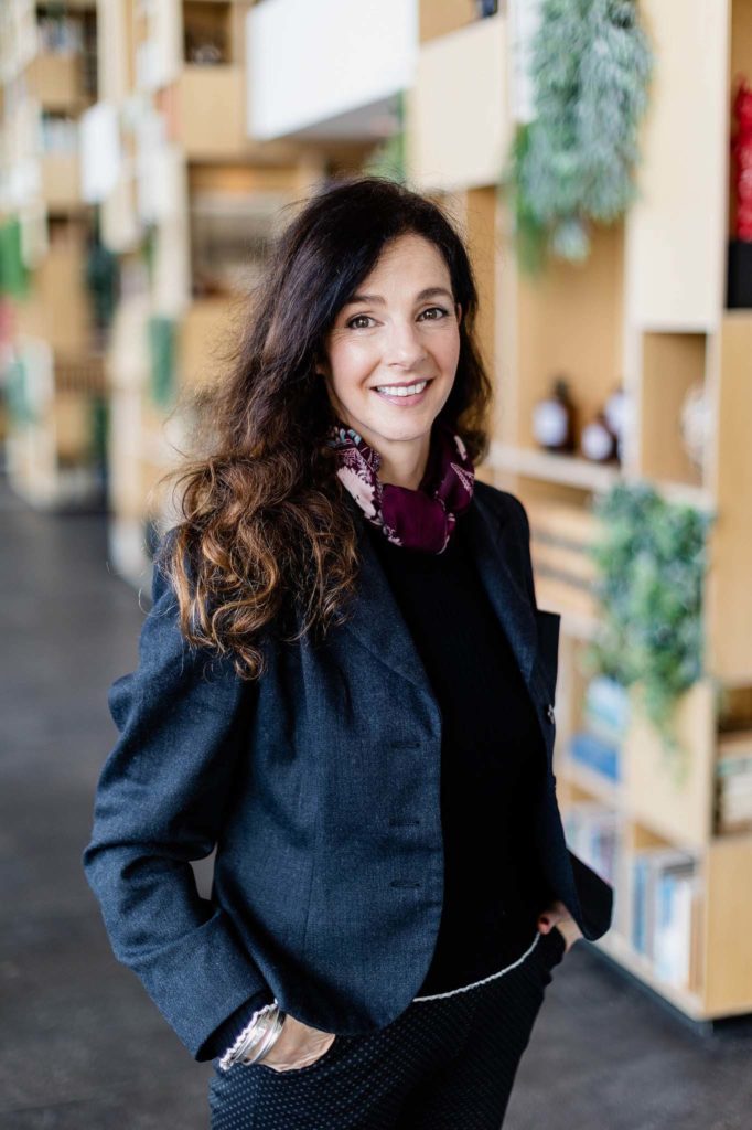 professional lady smiling at the camera whilst having her photo taken